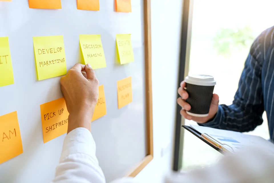 Team organising priorities with sticky notes